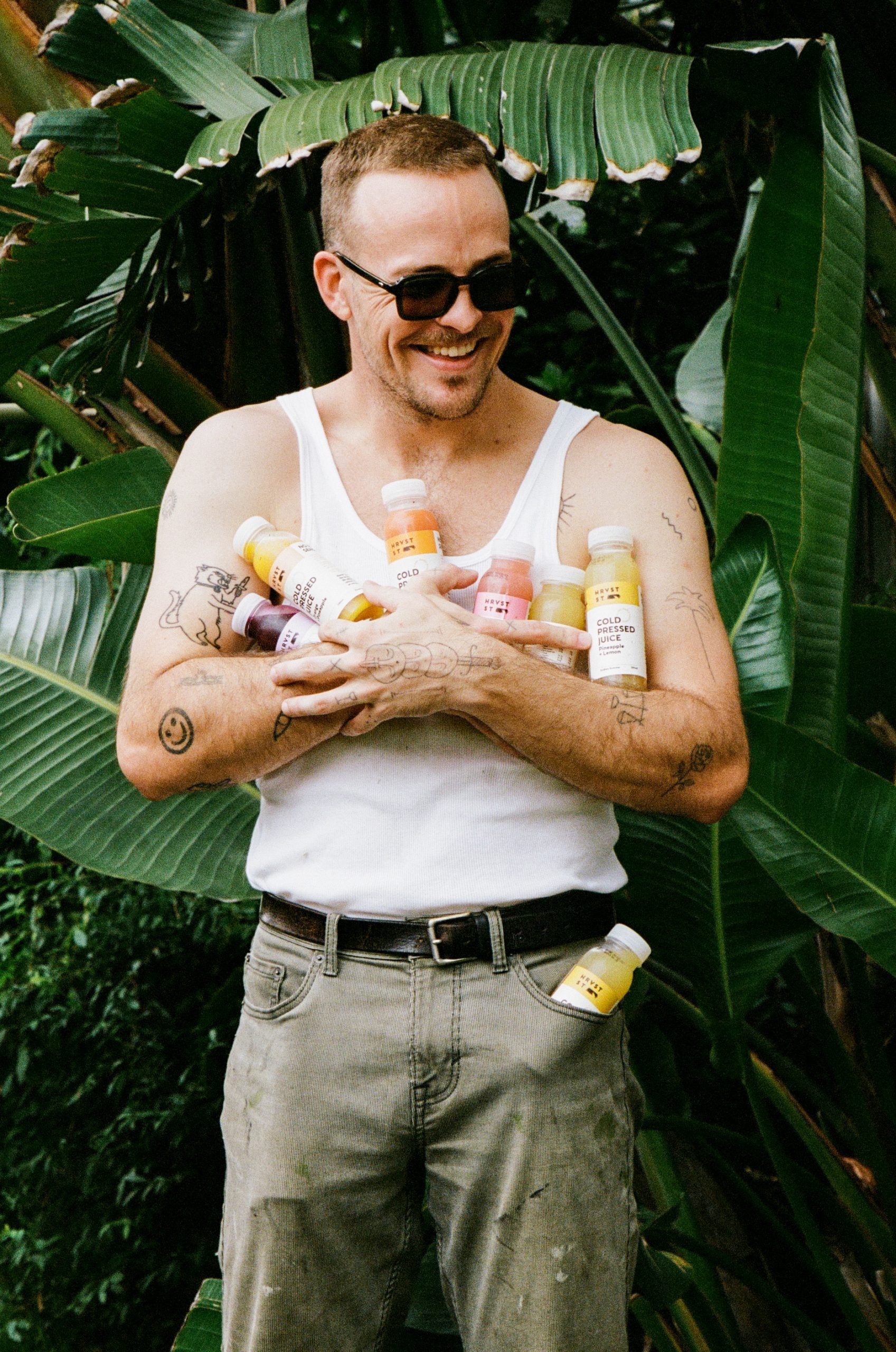 Happy man carrying Hrvst St juices